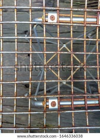 Close up of steel grating and blur wood panels background
