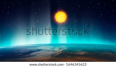 Northern lights (aurora borealis) over planet Earth with sun "Elements of this image furnished by NASA"