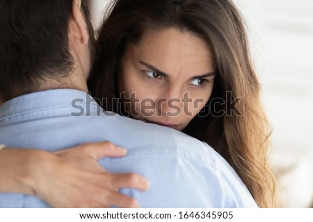 Pensive millennial girl hug boyfriend make peace after fight look in distance think of relationships problems, thoughtful young woman doubt relations ponder about breakup, distrust, cheating concept Royalty-Free Stock Photo #1646345905