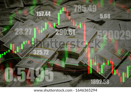 Stock quotes and charts on the background of bundles of dollars. Successful investments on the stock exchange. Profit from exchange operations. Profit from fluctuations in currency exchange rates.