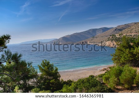 Seawater surface view horizon and the green pine trees with the mountains view on background, Greece paradise island Chios beach