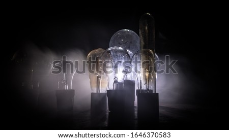 Beautiful retro luxury light lamp decor glowing. Abstract dark background with creative artwork decoration of glowing bulbs.