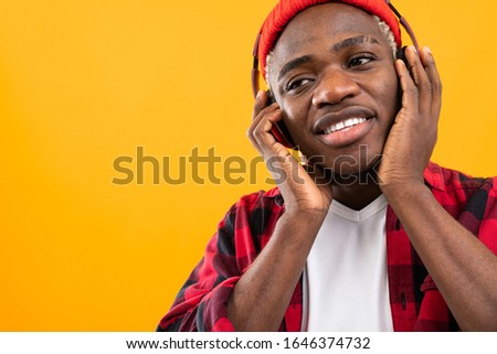 handsome black american man listening to music using headphones