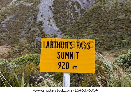 Yellow sign with the text "Arthur's Pass Summit, 920 m" at the State Highway 73 in Canterbury, New Zealand