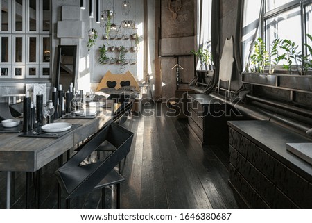 dark design of huge studio apartment in loft style ith big windows and black wooden contemporary furniture with free planing