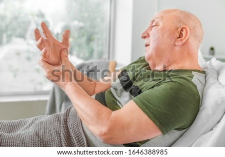 Senior man suffering from Parkinson syndrome in clinic Royalty-Free Stock Photo #1646388985
