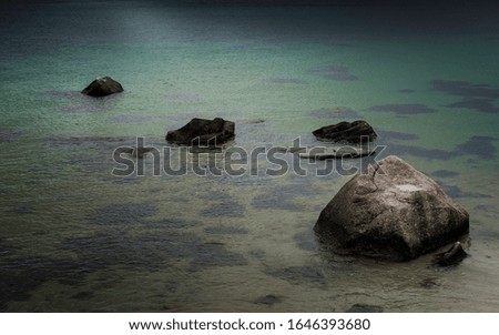 Zen like rocks in calm seawater tranquil backgrounds