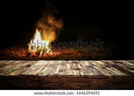 Table background of free space for your decoration and dark mood photo of campfire.Copy space and dark night time. 