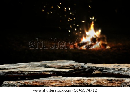 Table background of free space for your decoration and dark mood photo of campfire.Copy space and dark night time. 