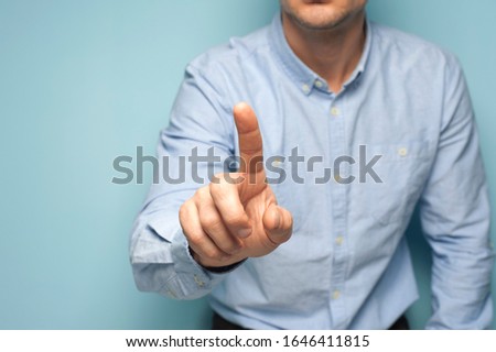 Unidentified man clicks his fingers on an invisible screen. Infographic concept and place for your text. Business and marketing advertising concept