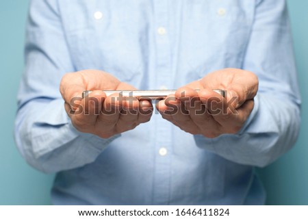 Closeup of an unidentified male hands types text on a smartphone. Business and social networks concept. Infographics and place for text