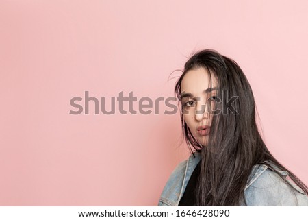 Portrait of happy middle-eastern female posing against a pink background. Studio portrait of a stylish young woman. 