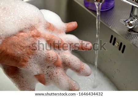 Proper handwashing includes five steps: wetting hands with clean running water; lathering soap on hands, scrubbing at least 20 seconds, rinsing hands; and drying them with an air dryer or clean towel Royalty-Free Stock Photo #1646434432