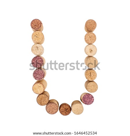 The letter "U" is made of wine corks. Isolated on white background