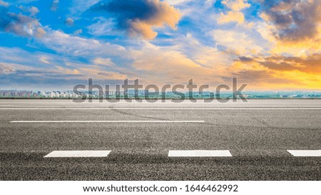 Wide asphalt highway and city suburb skyline in Shanghai at sunset,panoramic view.