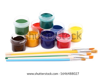 Colorful gouache paints and brushes isolated on white background