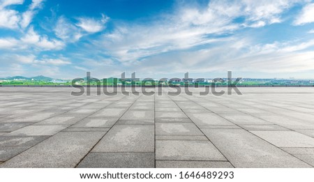 Wide square floor and city suburb skyline on a sunny day in Shanghai,panoramic view.