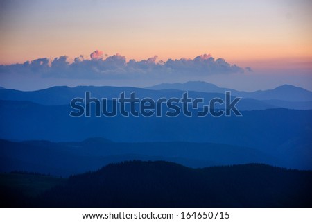blue color of mountains during sunset