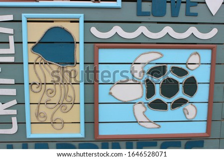 Wooden signboard with the words Summer, Sun, Love.  summer pattern, the Concept of a summer holiday on the beach.
