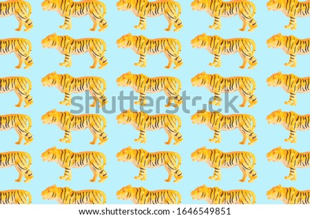 Group of plastic tiger doll isolated on color background