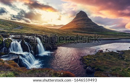 Scenic image of Iceland. Great view on famouse Mount Kirkjufell With Kirkjufell waterfall during sunset. Wonderful Nature landscape. Popular Travel destinations. Picture of wild area