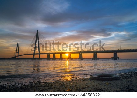 Silhouette of bridge views during sunset at Desaru Kota Tinggi Johor Malaysia. This image may contain noise ,blurry clouds due to long exposure, soft focus and poor lighting