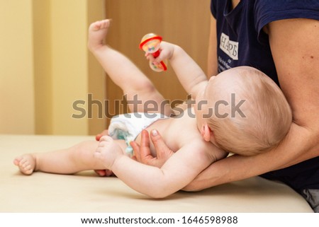 Pediatric Physical Therapy - an infant exercising on a table