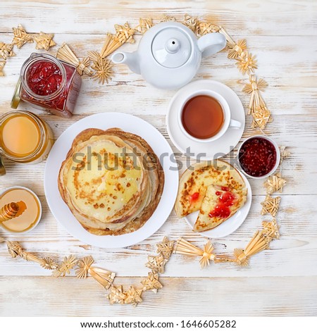 Pancakes, teapot, honey and jam on white wooden table. Pancake week, slavic traditional holiday Maslenitsa. flat lay. 