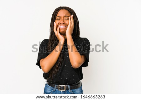 Young african american woman isolated on white background whining and crying disconsolately.