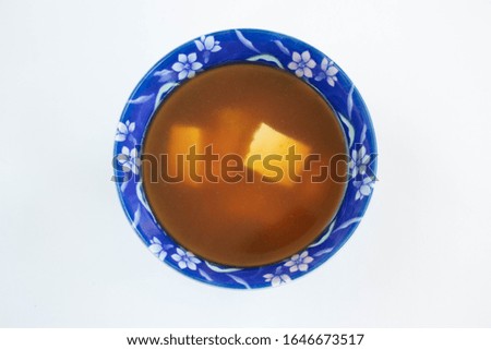 Miso soup with tofu on a white background