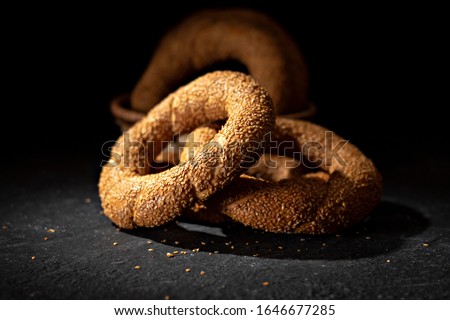 A close-up of Turkish Bagel / Simit withe sesame seeds, on black background. - Image. - Image
 Royalty-Free Stock Photo #1646677285