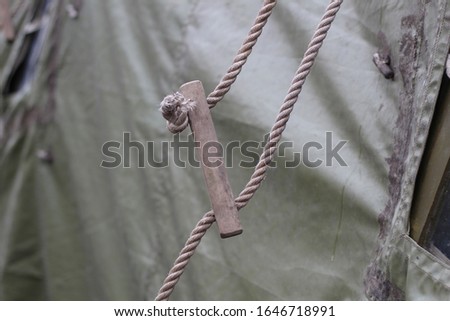 Ropes for attaching mobile army tents. Fasteners of prefabricated tarpaulin military tents.