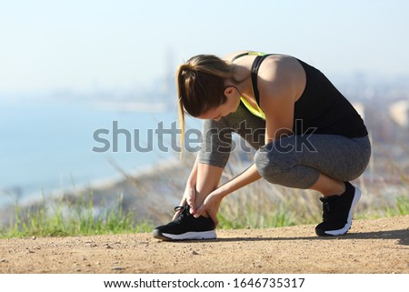 Runner suffering ankle injury after sport outdoors in a city outskirts Royalty-Free Stock Photo #1646735317