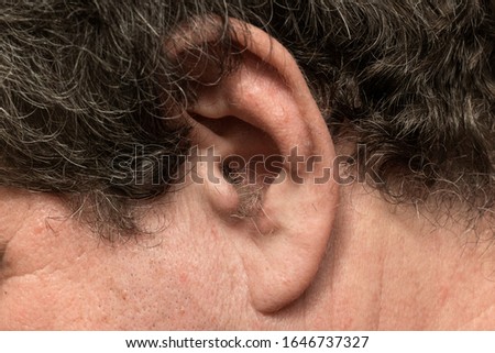 Hair in the ear of a mature adult male close-up
