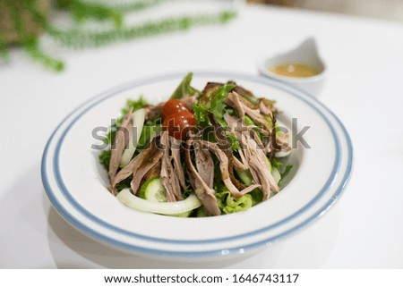 Duck grill salad serve with special  salad dressing