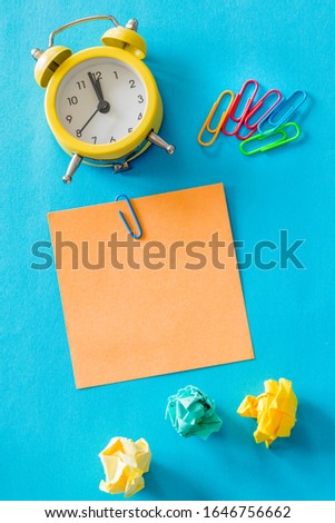 alarm clock, together with a handwritten inscription "Planning" Top View.  colored office staples, blotted paper balls, concept