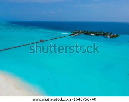 Nice beach with beach chairs, thatched umbrellas. luxury beach against the background of the beauty of the sea with coral reefs. Travel summer holiday background concept. frame with place for text