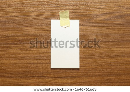 Blank business cards glued with yellow tape on a wooden surface and free space, 3.5 x 2 inches size as template for design presentation, showcase etc.
