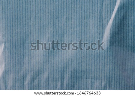 Wrinkled striped blue paper background close up view