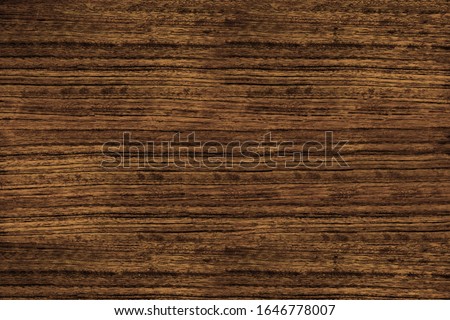 Heavily textured straight grain dark brown mozambique wood texture