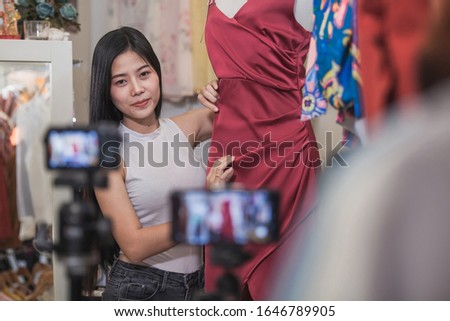 Young Asia girl selling clothes online by live streaming. selling it online live streaming Concept