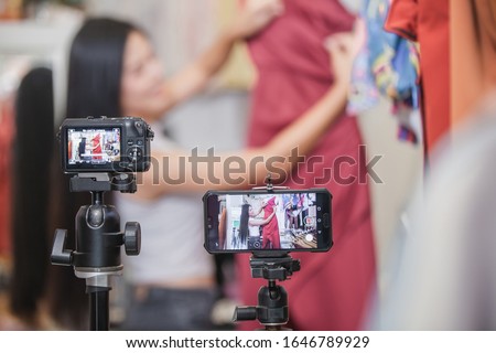 Young Asia girl selling clothes online by live streaming. selling it online live streaming Concept Royalty-Free Stock Photo #1646789929