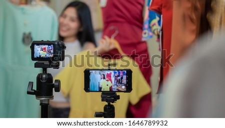 Young Asia girl selling clothes online by live streaming. selling it online live streaming Concept Royalty-Free Stock Photo #1646789932