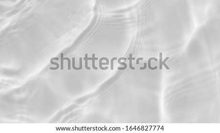 Subtle white texture of light-shadow pattern of sunlight reflection from rippled water surface. Beautiful natural pattern with 3D feeling. White-grey water waves marbling. Royalty-Free Stock Photo #1646827774