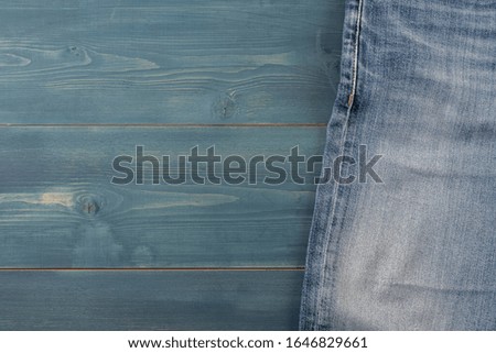 Blue jeans on a blue wooden background