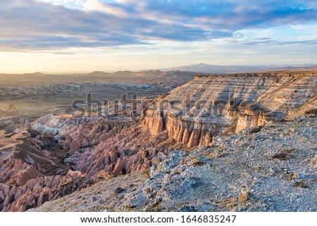 Bright aerial view down to rose valley after sunset over the horizon.Dramatic rocky pink  and white colorful landscapes with textures .Turkey landscapes in  Kapadokya.2020