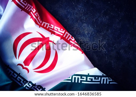 National flag of Iran on a dark background with space for text