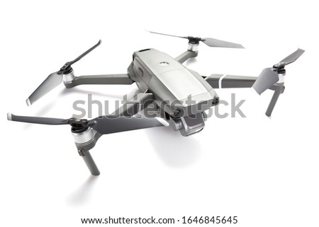 Modern drone quadcopter with a camera isolated on white background