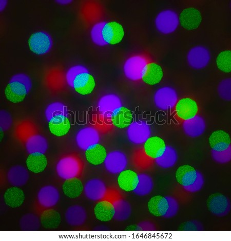 Abstract defocus background, colored green red violet purple dot circle. Illumination blurry lights, pixelated dotted abstract picture of rainbow light spots, electric LED lighting