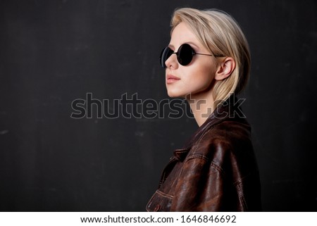 Beautiful blonde woman in sunglasses and style jacket 